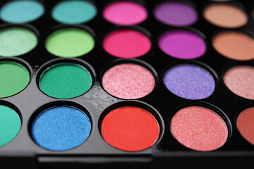 Beautiful eyeshadow palette as background, closeup. Professional cosmetic product