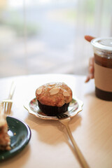 Banana cupcakes and almond toping. Breakfast In a coffee shop at the cafe , during business work concept