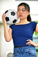 Unemotional Sporty Chinese Person With Soccer Ball