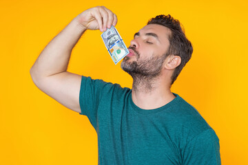 Man hold money on yellow studio isolated background. Portrait of rich man with money dollar bills....
