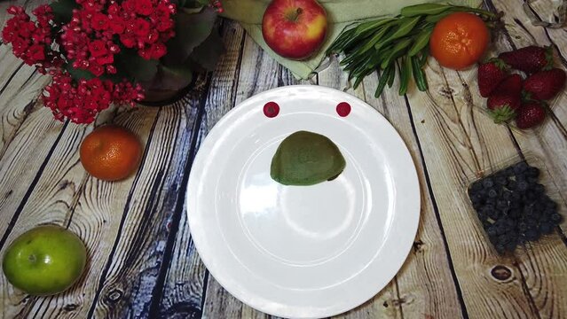 Plate with turtle pancake spins on the wooden table and dissapear. Stop motion flat lay. High quality 4k footage