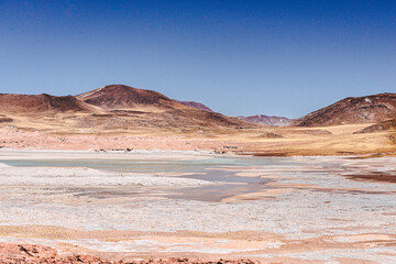 Paisajes de San Pedro de atacama, caracterizado por colores tierra propios del desierto, cultura indígena, diversidad de accidentes geográficos, turismo.