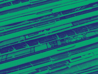 Old vintage comic books stacked in a pile makes background paper texture with blue green color effect