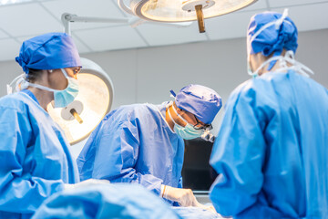 Professional doctors performing surgical operation in operating room. 
