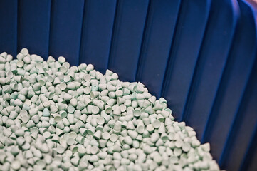 Abrasive polishing granules in blue container macro view
