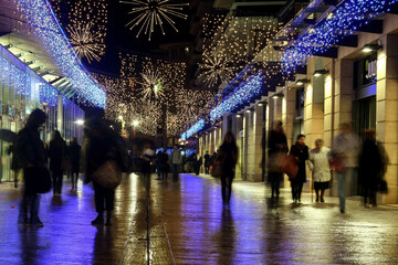AIX EN PROVENCE, FRANCE - NOVEMBER 28, 2008: Blurred people walking among the shops and stores of...