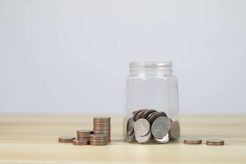 Hand putting coins in the piggy bank. future investment	