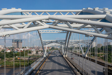 Naklejka premium Dong Tru bridge against blue sky in Hanoi, Vietnam