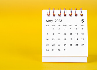 The May 2023 Monthly desk calendar for 2023 year on yellow background.