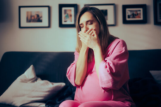 Pregnant Woman in her Third Trimester Feeling Sick at Home. Mother to be suffering from morning sickness late into her pregnancy
