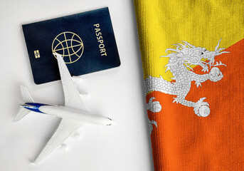 Flag of Bhutan with passport and toy airplane. Flight travel concept 