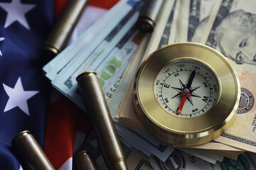 Money bill with golden Compass. Bullets and cartridge cases as a military concept. Close up US Currency and compass. business, financial idea, concept, symbol of crisis, inflation
