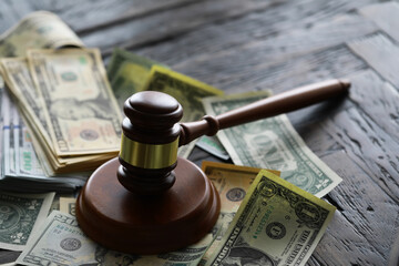 judge gavel and money on brown wooden table concept