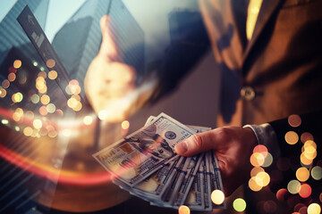 Business executive in formal suit giving money as a bribe. Double exposure skyscraper