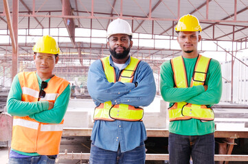 Smiling engineers and construction workers at the job site.
