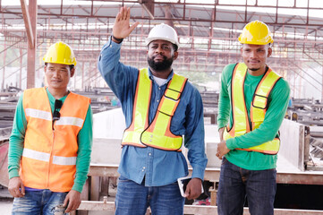 Smiling engineers and construction workers at the job site.