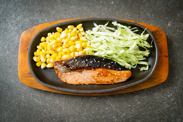 grilled salmon fillet steak on hot plate