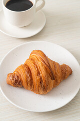 fresh croissant on white plate