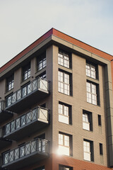 Modern office building exterior with glass facade on clear sky background. Transparent glass wall of office building with yellow decoration. Abstract Structure Element of facade of modern European
