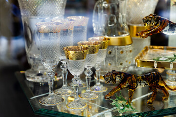 Fototapeta na wymiar Original Bohemian art glass figures and glassware on display in czech souvenir shop ..