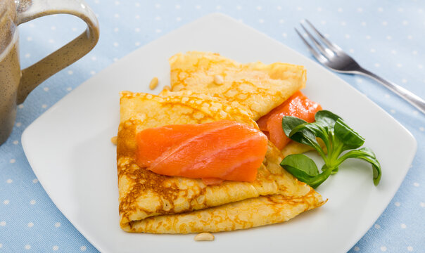 Delicious pancakes with salted salmon. High quality photo