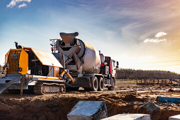 Concrete mixer truck delivers concrete to the pump for pouring piles. Concrete pump at the...