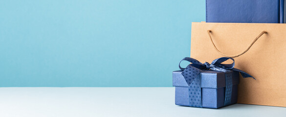Small luxury gift box with blue bow paper bag and agenda. Side view. Fathers day or Valentines day...