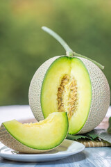Crown Musk Melon on nature background, Shizuoka Crown Melon Yama Grade on Green bokeh background.