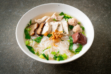 Vietnamese Rice Noodles Soup with Vietnamese Sausage served vegetables and crispy onion