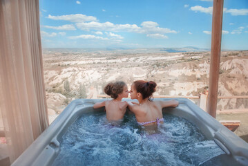 Beautiful girls in the jacuzzi. Sisters on vacation. Rest at the hotel. Mom and daughter. Holidays. Vacation. Jacuzzi on the roof. Jacuzzi with a beautiful view. Relax. Cappadocia. Turkish breakfast.