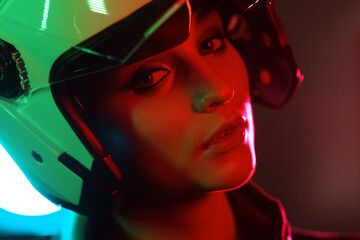 Portrait of a beautiful and young girl in cyberpunk style. Mixed color light effect. Futuristic...