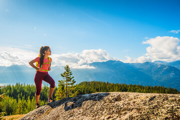 Naklejka na ściany i meble Hiking woman hiker on mountain hike trail enjoying view wearing backpack and hiking clothing in beautiful blue sky nature landscape