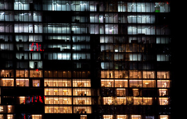 Obraz na płótnie Canvas Illuminated windows at night in downtown SIngapore