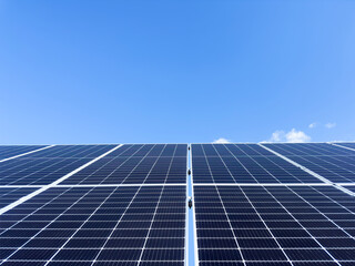 Blue Solar panel over blue sky, sun and clouds. Solar panels pattern for sustainable energy. Renewable solar energy. Alternative energy.