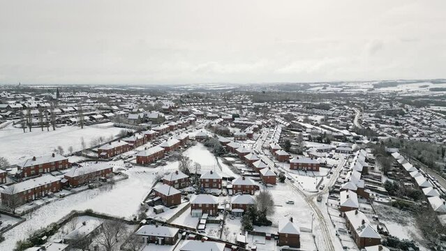Urban Winter Scene. Aerial Drone Video Footage showing a snowy landscape in a suburban UK town.