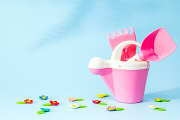 Children's toy tools for gardening on a blue background