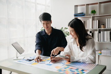 Asian businessman and woman people meeting in office. Employee brainstorm and work as team, plan and discuss project by point on paper and tablet. .