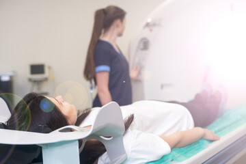Radiologist with a female patient in the room of computed tomography