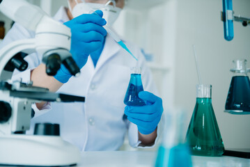 Fototapeta premium Male scientist researcher conducting an experiment working in chemical laboratory