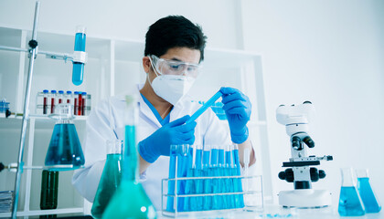 Scientist mixing chemical liquids in the chemistry lab. Researcher working in the chemical laboratory.