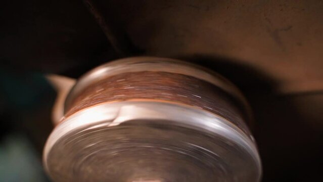 Worn abrasive wheel of a grinder close-up. Stopping the machine for sharpening metal