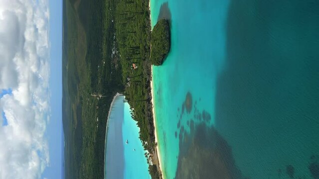 Vertical aerial push in to Kuto Peninsula separating Kuto, Kanumera Bays Isle of Pines.