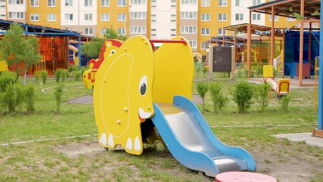 Summer playground without children on home area of high-rise buildings