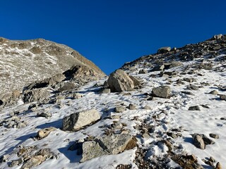 Fresh tracks on the season's first early autumn snow above the road pass Fluela (Fl&uuml;elapass) and in the Swiss Albula Alps mountain massif, Zernez - Canton of Grisons, Switzerland (Kanton Graub&uuml;nden)