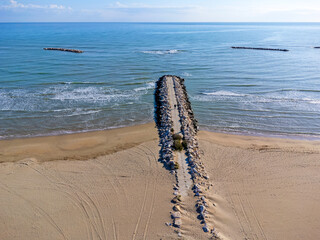 Lanscape aerial view, Italy Pescara. Empty beach, waves, sea, coast, sand, rocks.
