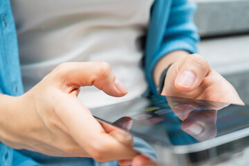 Hand using smartphone in public areas, During leisure time. The concept of using the phone is essential in everyday life.