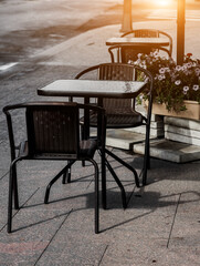 table and chairs at a sidewalk cafe.