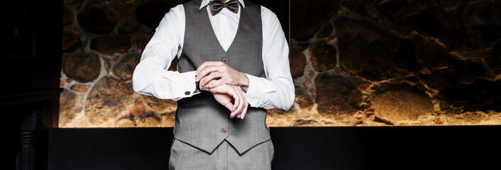 Groom in suit and bowtie correct watch.