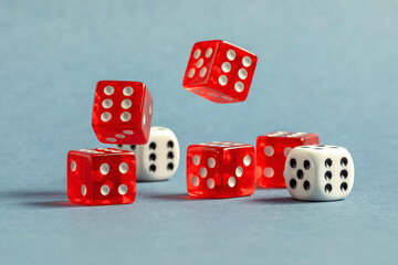 Random number generator. Red and white dice with numerical values lie in a chaotic order.