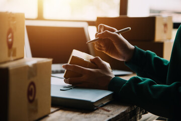 Obraz premium Business woman start up small business entrepreneur SME success .freelance woman working at home with Online Parcel delivery. SME and packaging deliveryconcept